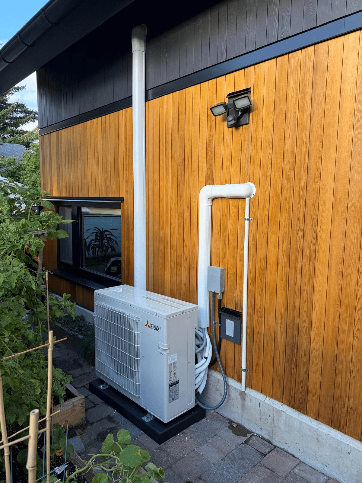 Outdoor heat pump mini-split condenser unit at a Coquitlam area home